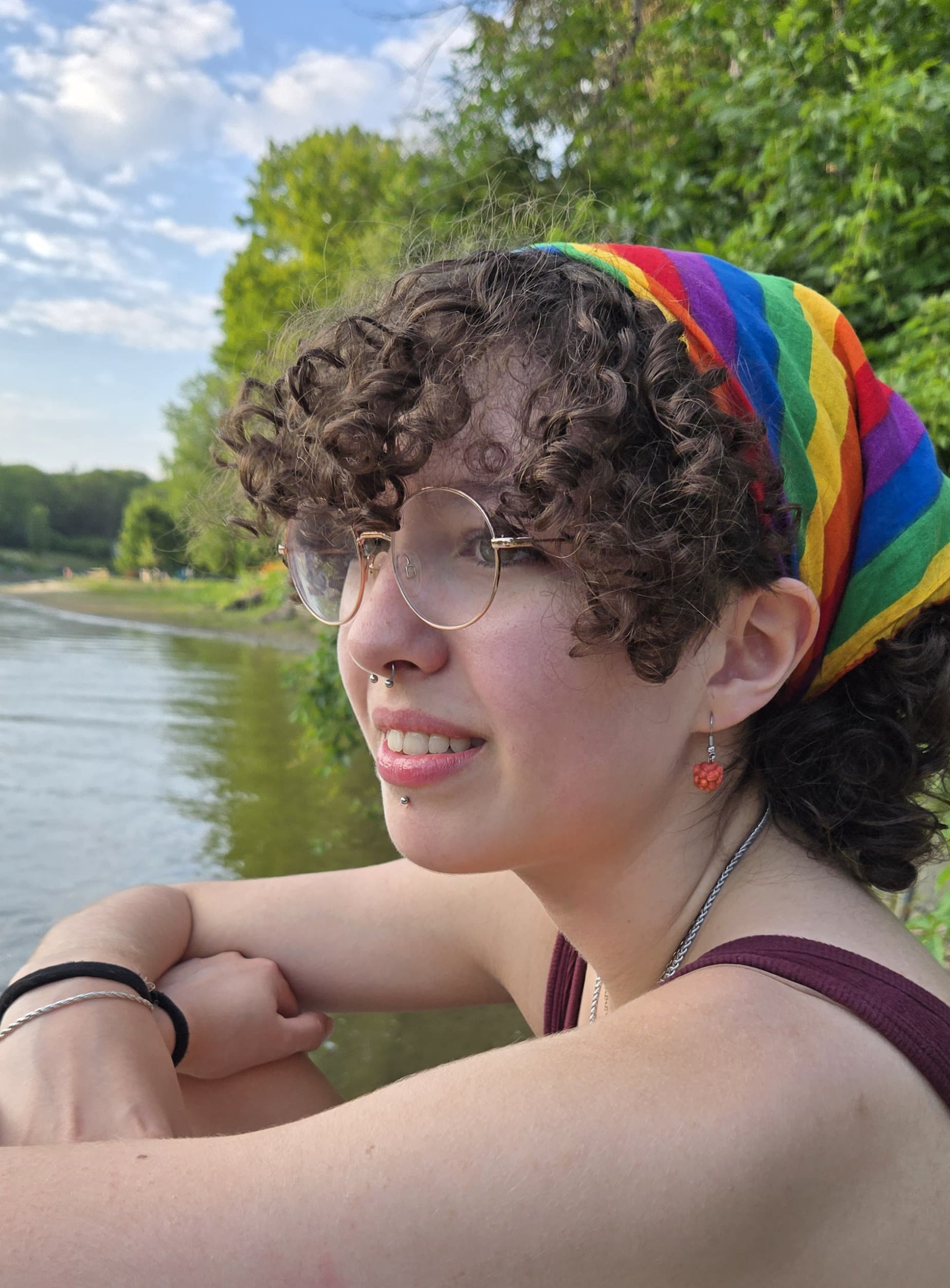 Amber Kopas smiling on a river's dock.
